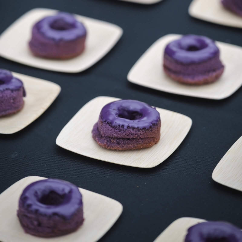 A table full of purple glazed doughnuts at the Oregon AAPI Food & Wine Fest